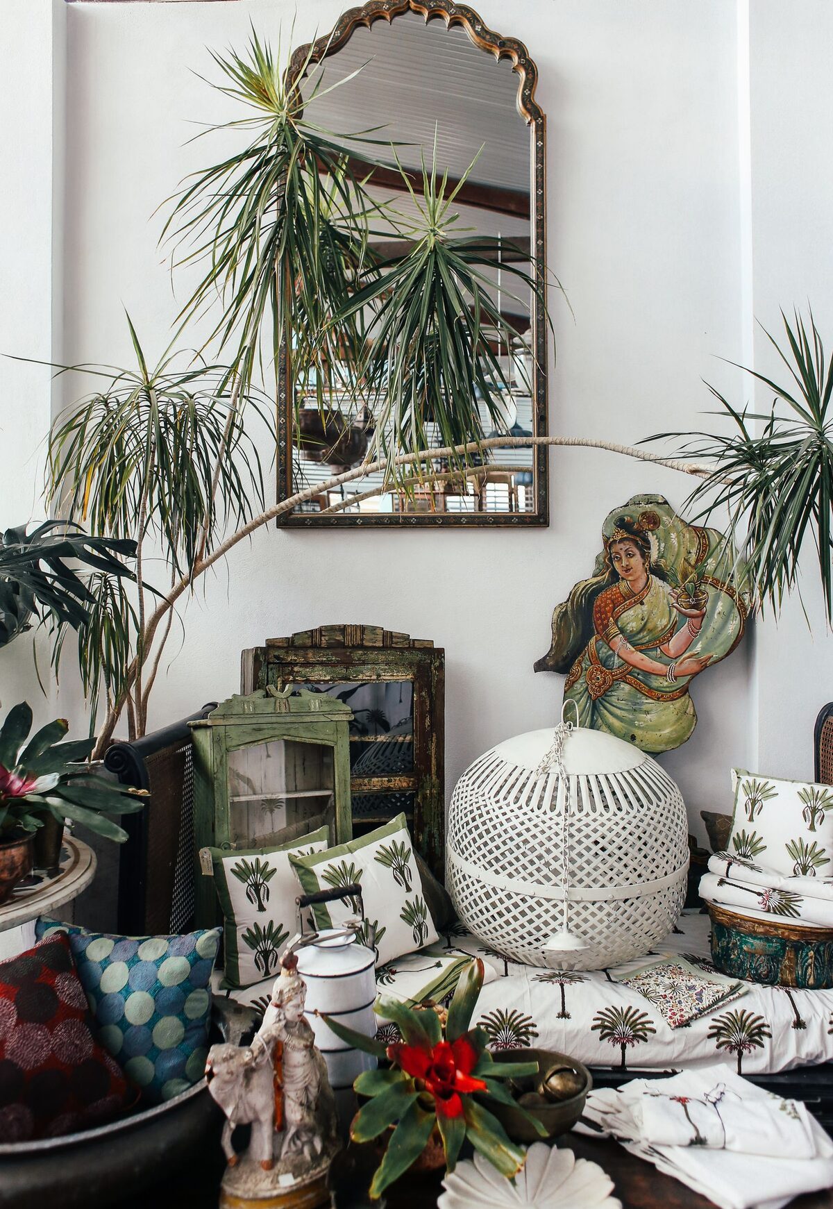 Boho corner room at Villa Amara dressed with trailing plants, framed art and warm textiles